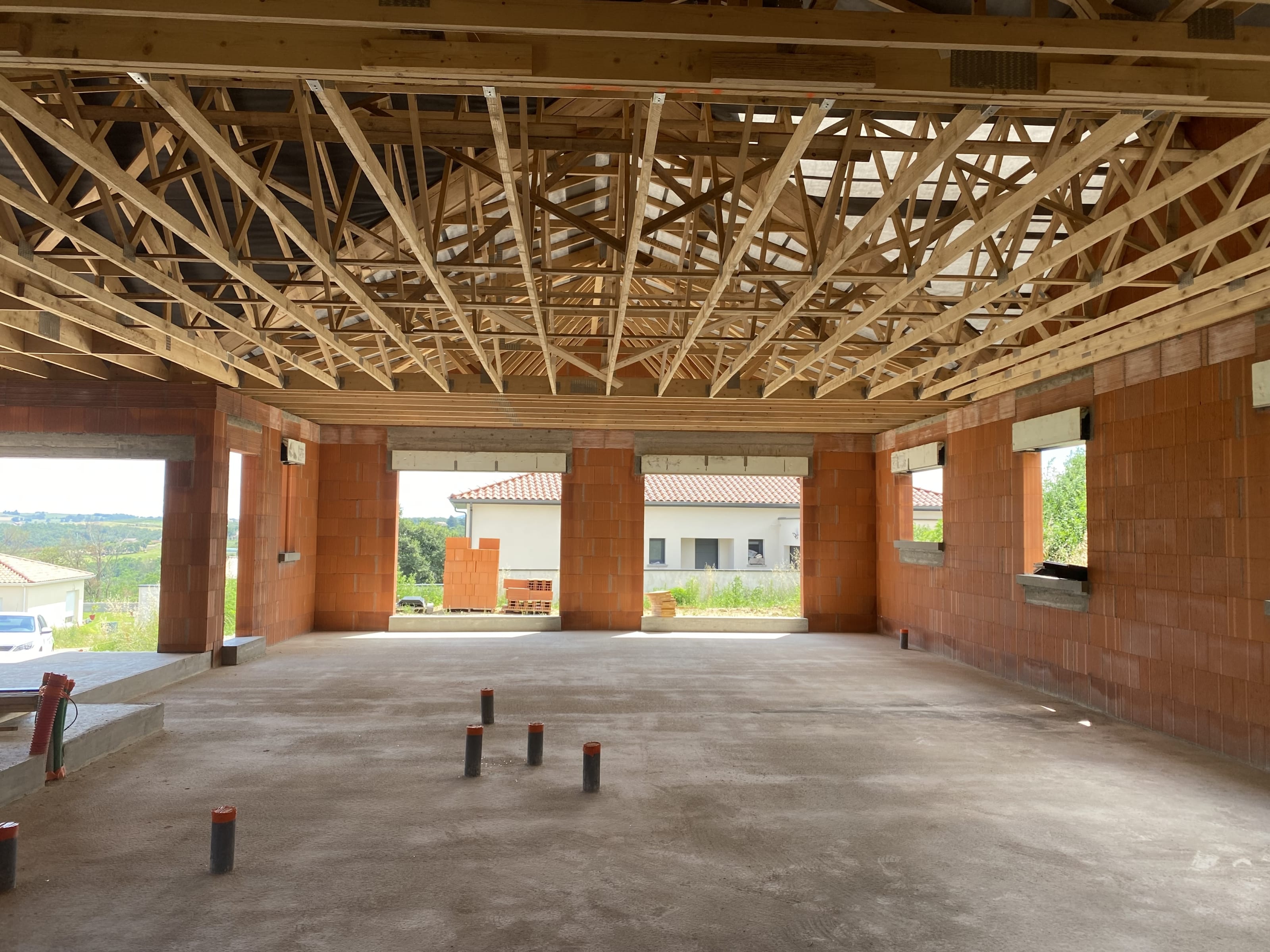 Lexique de la construction de maison individuelle par La Maison Des Compagnons, incluant des termes clés comme fondations, charpente, et isolation pour aider à comprendre le jargon du secteur. Maison en cours de construction par La Maison Des Compagnons, montrant des travaux en cours sur le chantier pour illustrer le processus de construction. Lexique de la construction de maison